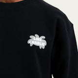 Detail van het Like Charlie-borduursel op de Branded Sweater Black